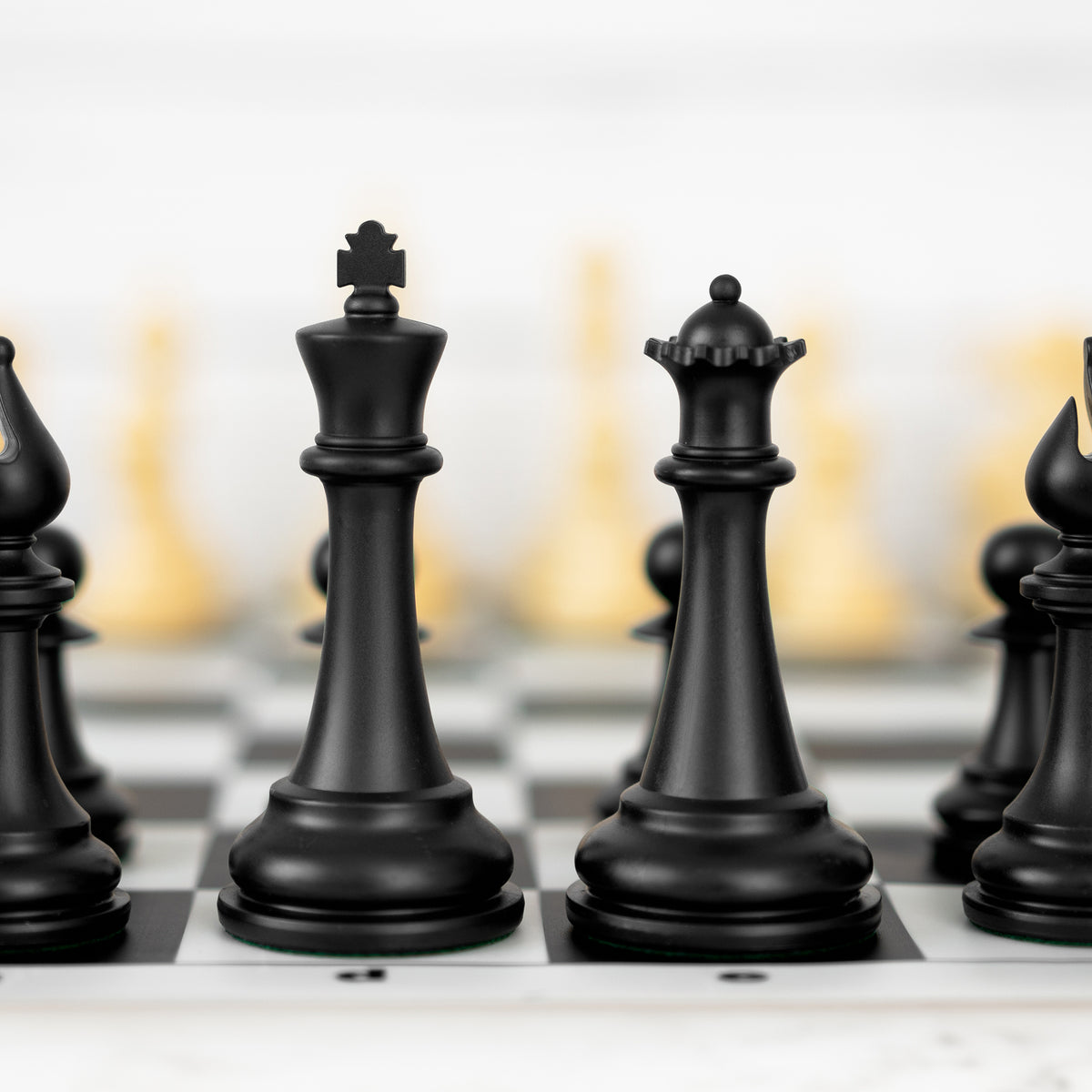 Black 4X king and queen on the board, cream pieces behind