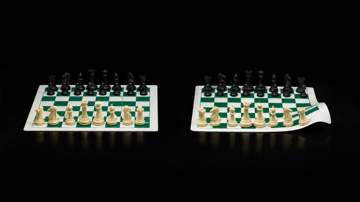 A flat green and white silicone chess board beside a vinyl board curling at the corner