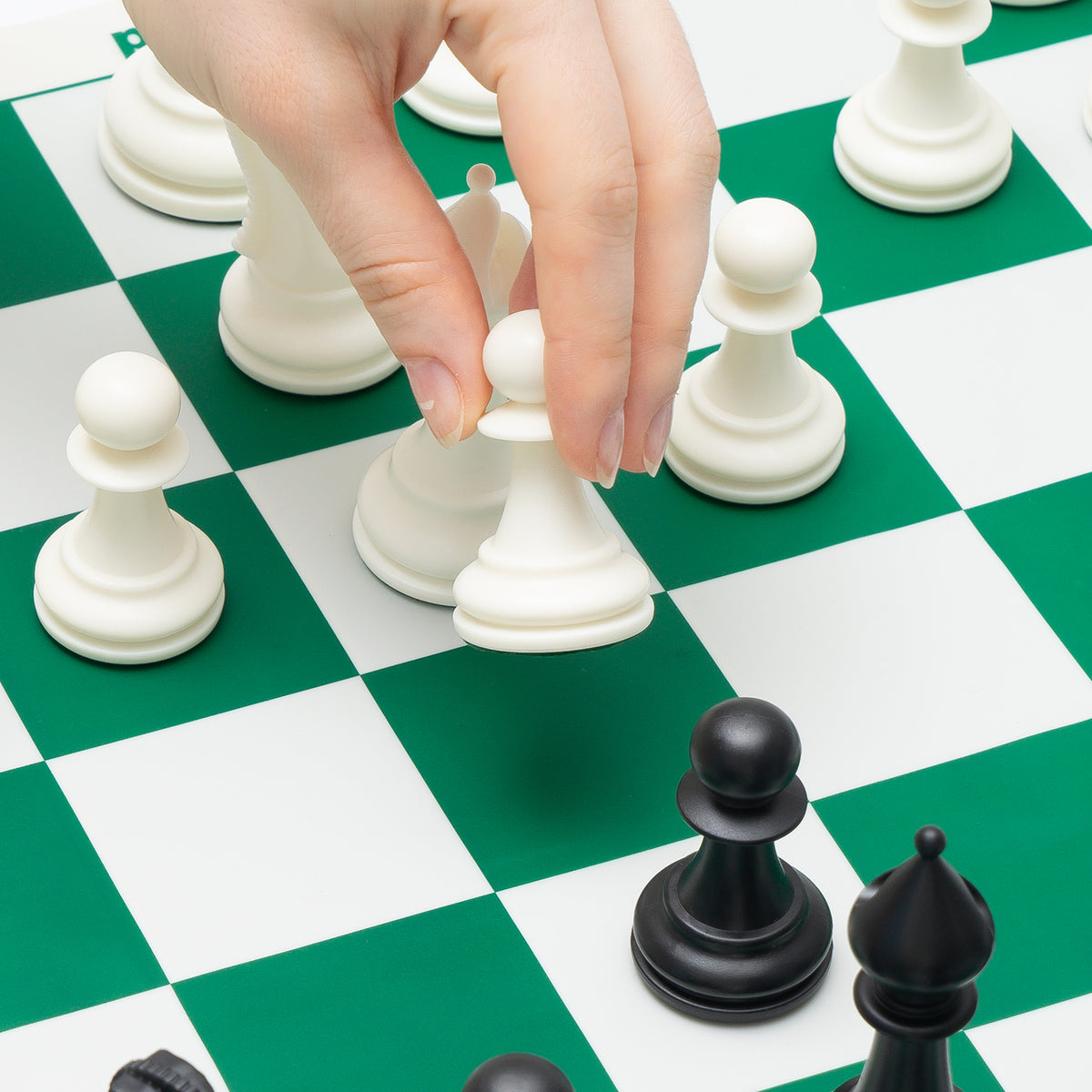 A game in progress on the green and white side of the 20 by 20 inch silicone board
